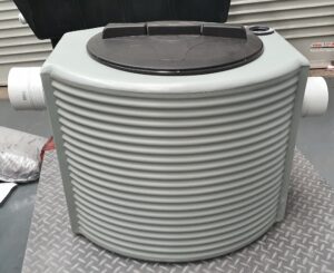 150L grease trap with grey ribbed polyethylene body, black inspection lid, and dual side inlet and outlet connections